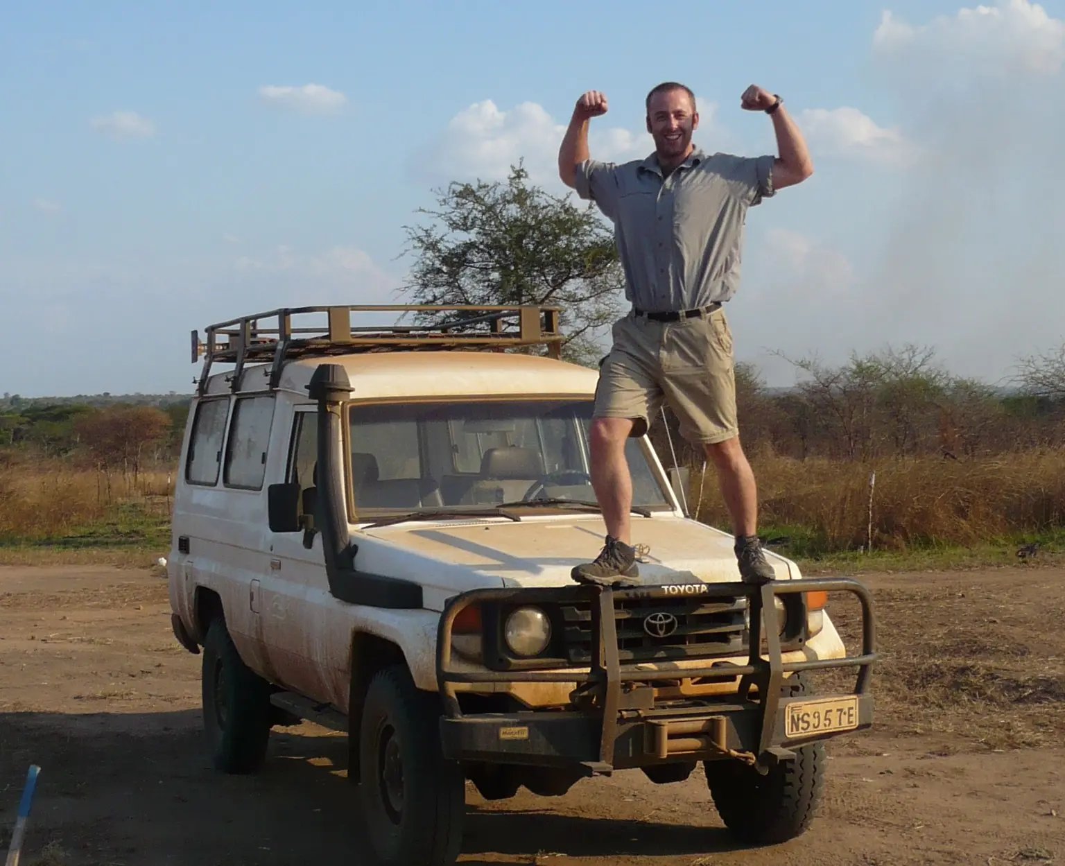 Sam Burgess standing on a tank in the desert